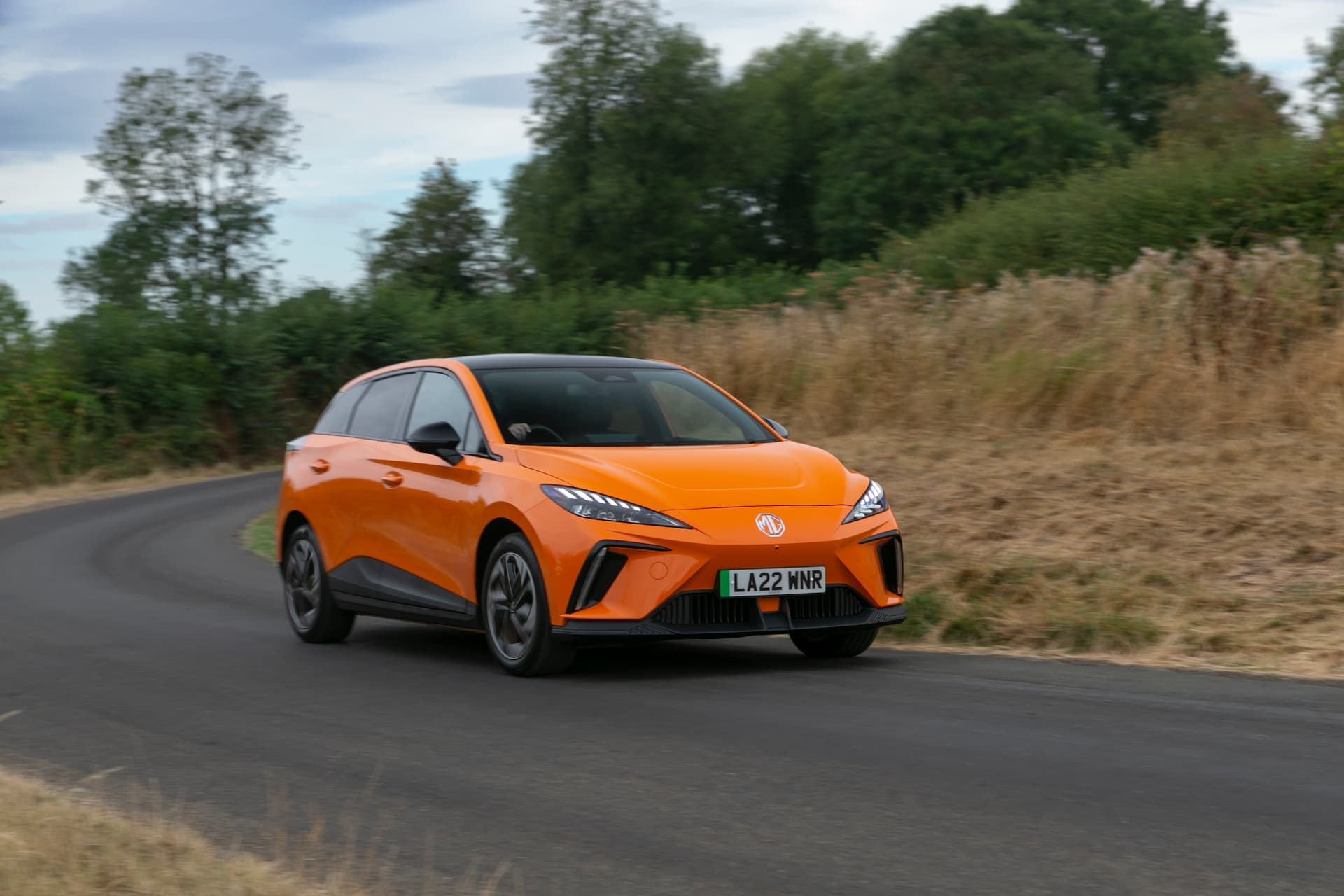 Orange MG 4 driving in UK roads Orange MG 4 driving in UK roads
